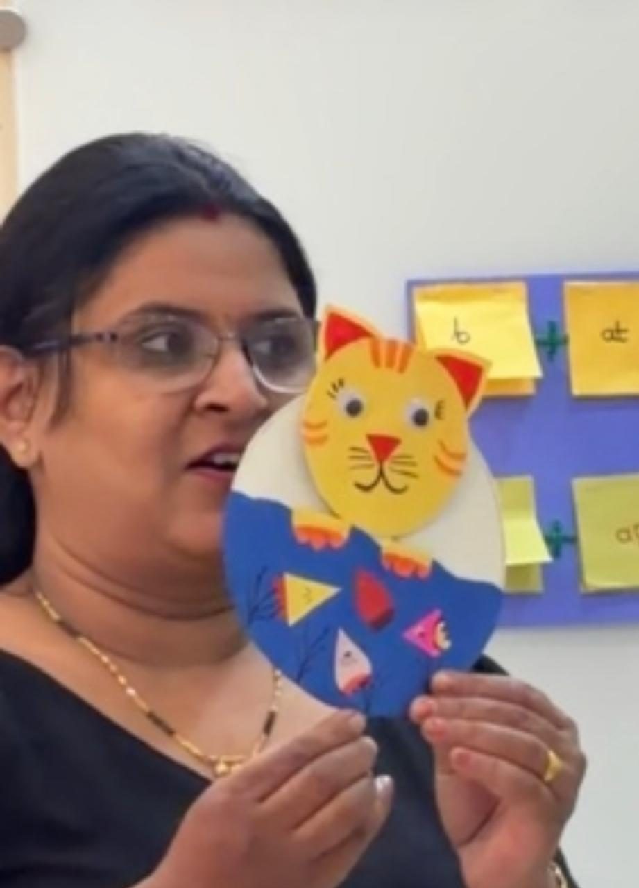 Instructor teaching with colourful alphabet teaching aids